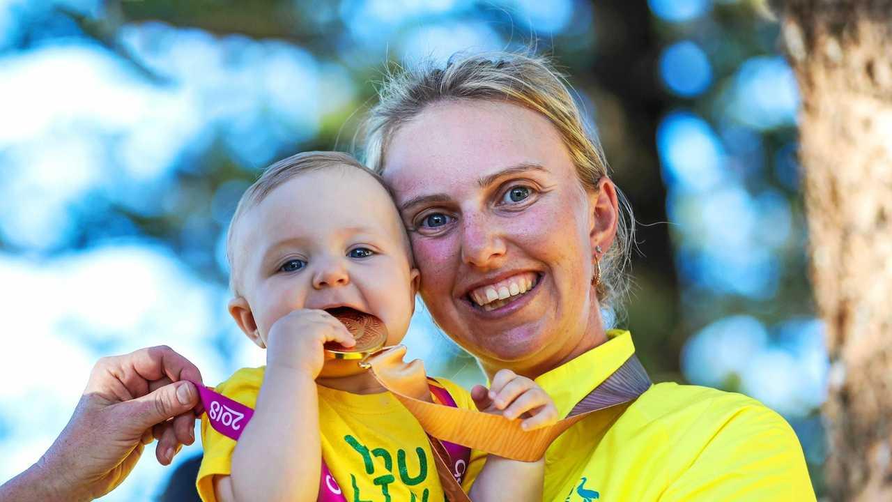 Kelsey Cottrell with her medal and child